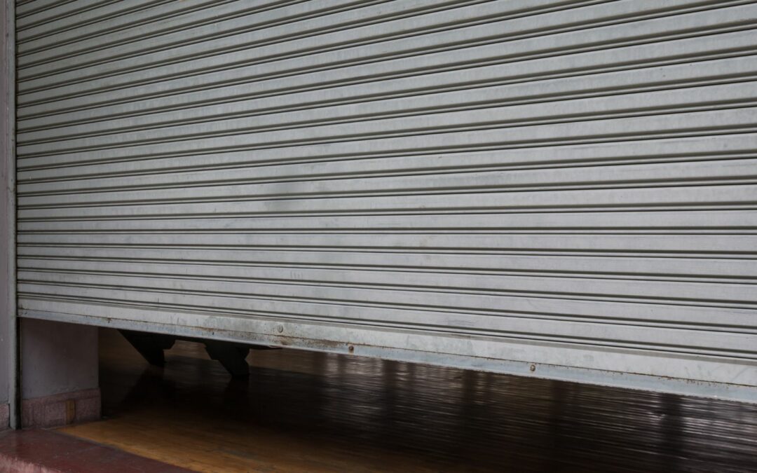 An example of steel garage doors that is rolled up slightly